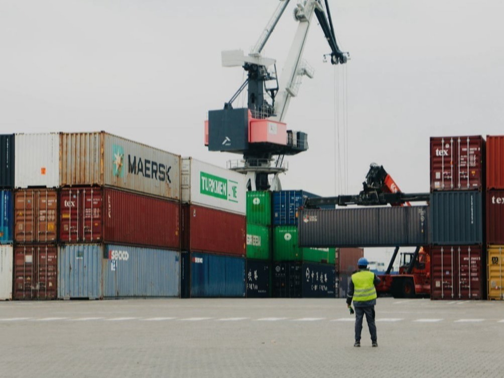 a man standing in front of a large crane